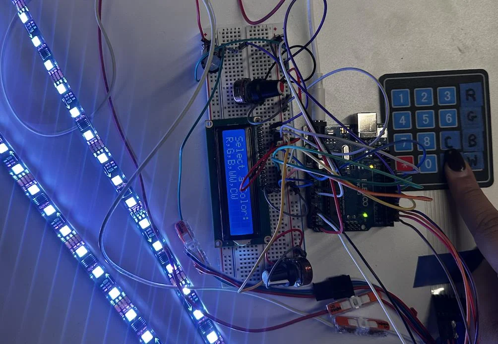 Prototype 0 on the bench: Arduino, keypad, knob, LCD and a blue LED strip