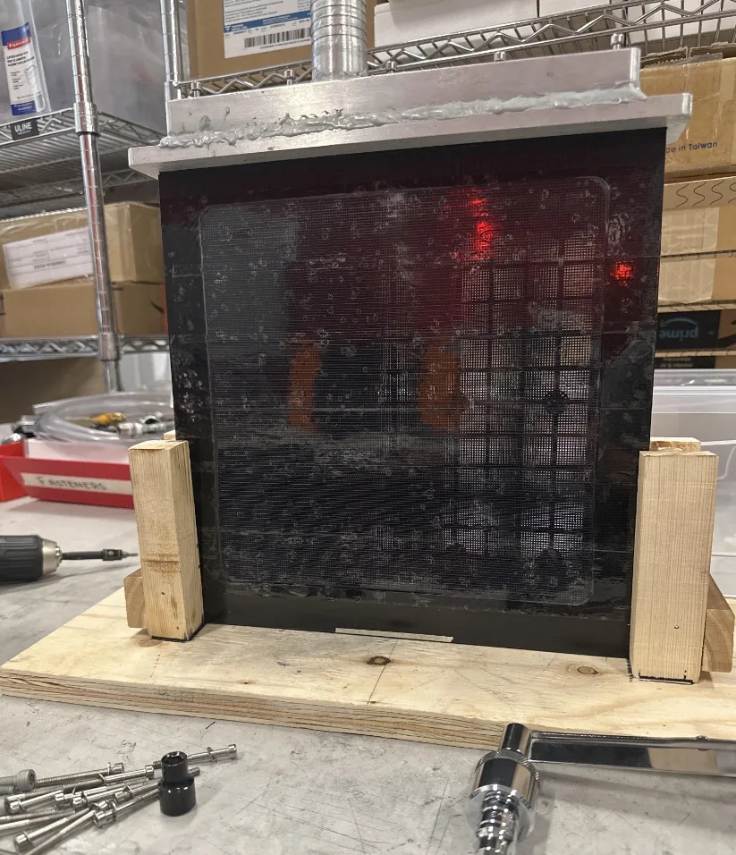 Machined fixture holding a membrane panel for dehumidification testing